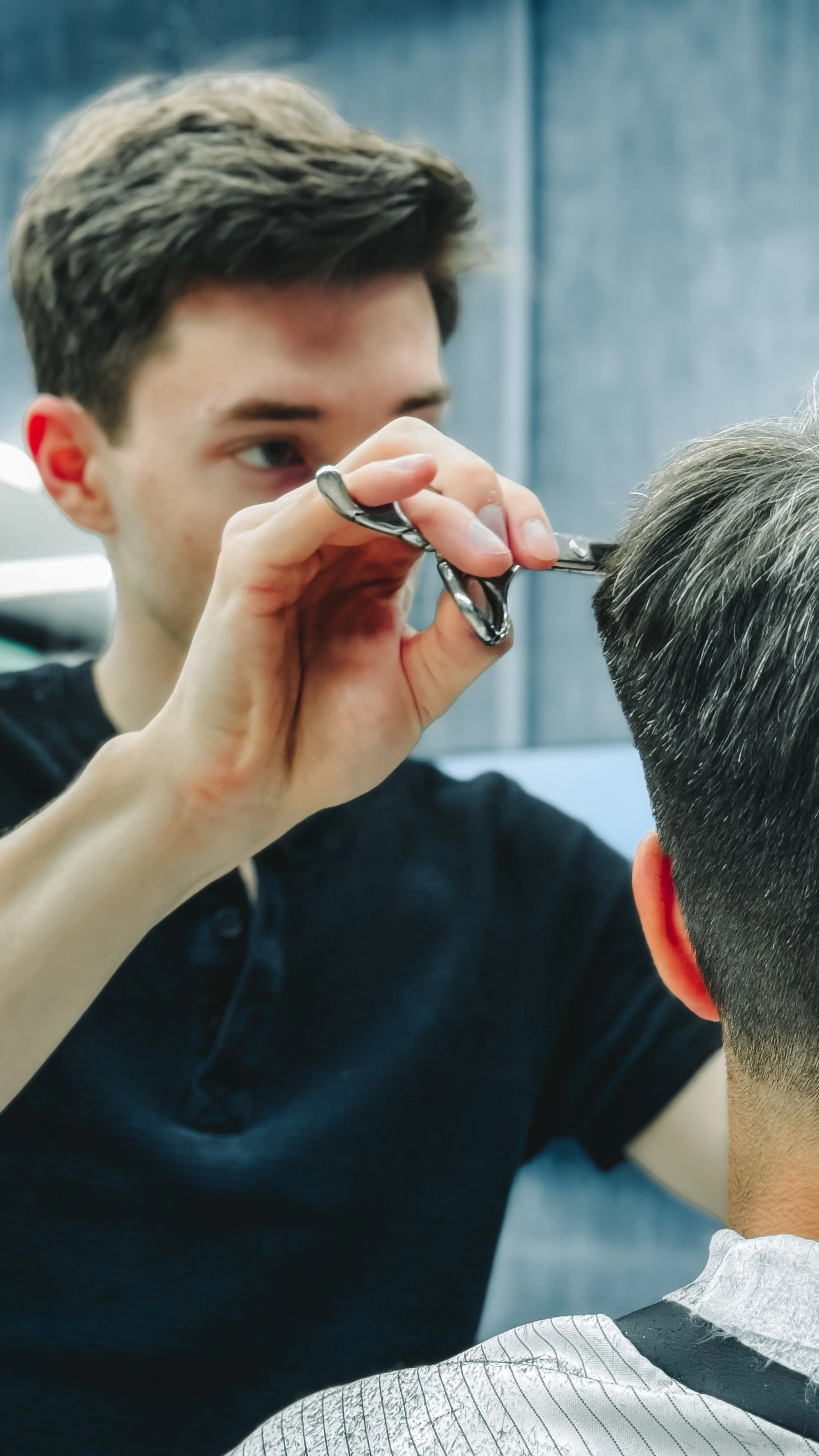 Barber focused on cutting a client's hair